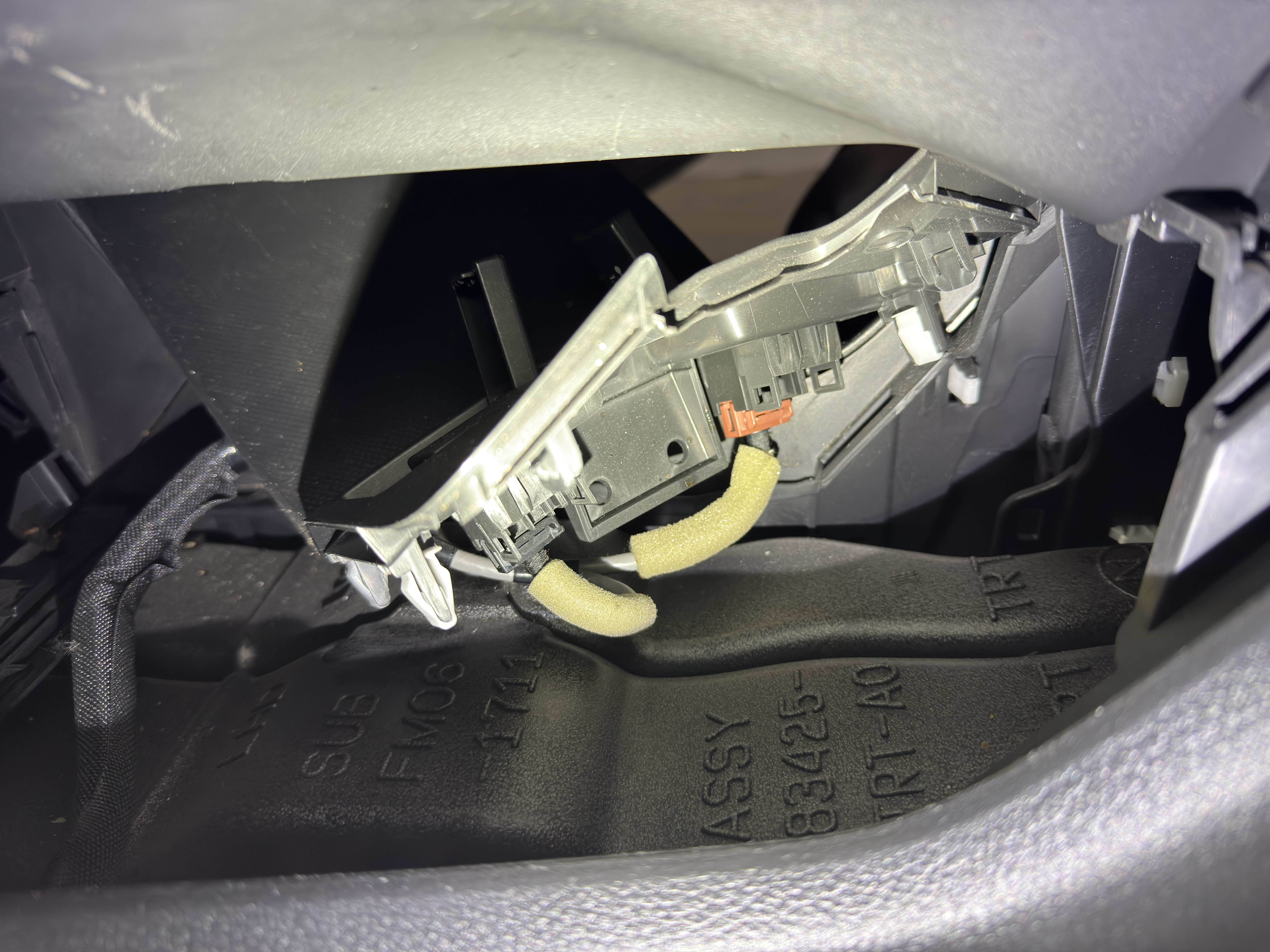 Once the panel is loose, you can disconnect the wiring harness.