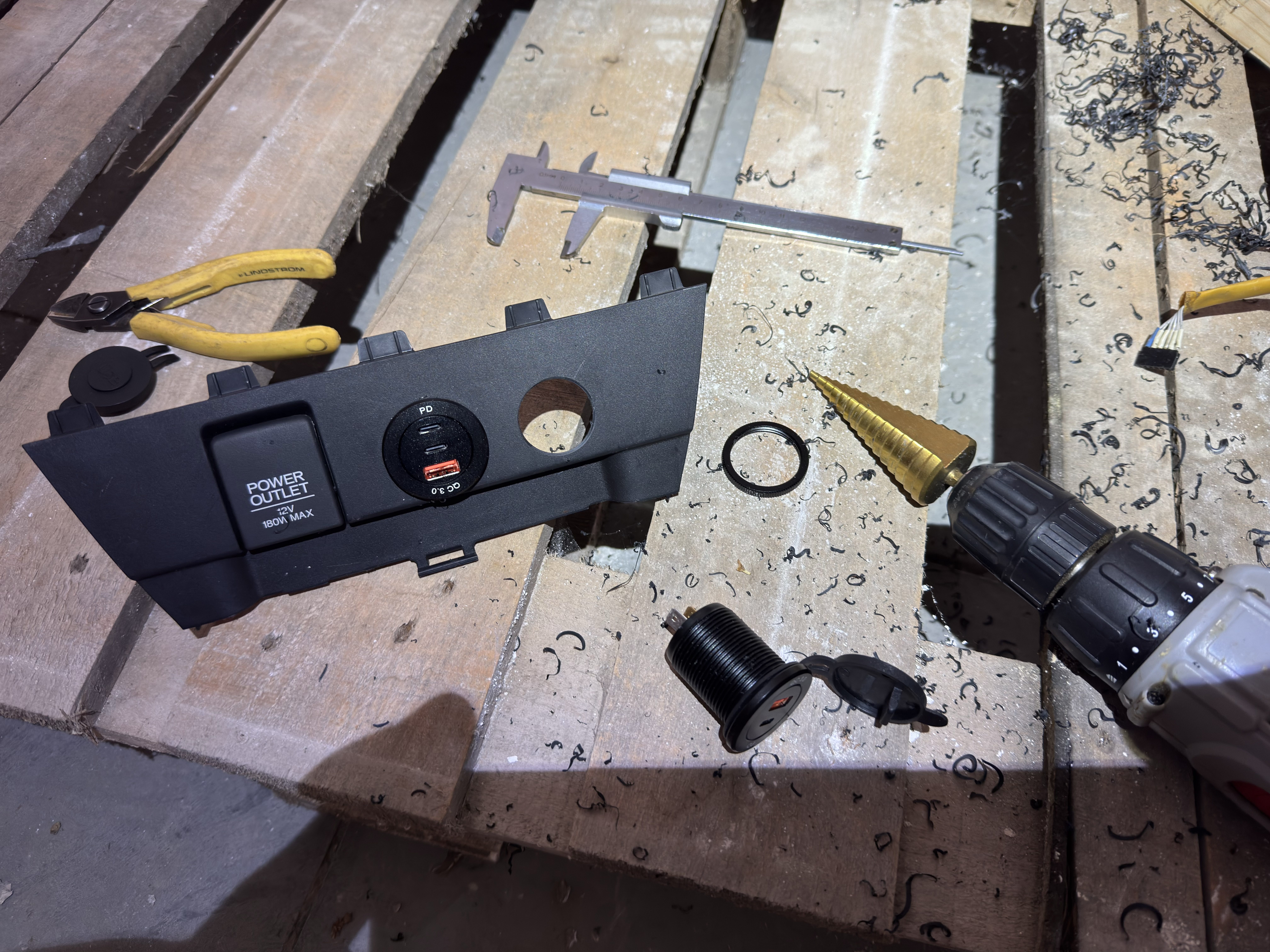 Use a step drill to create the holes for the new sockets. Measure the diameter
of your USB-C chargers to ensure a snug fit.